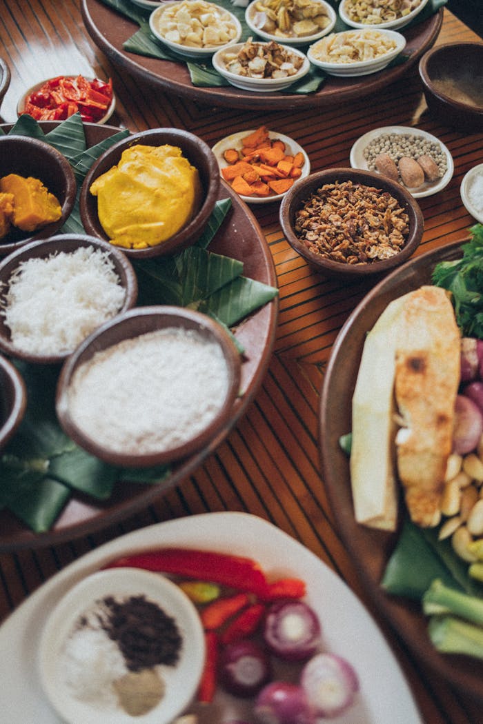 A vibrant assortment of spices and ingredients displayed on a wooden table, perfect for culinary exploration.